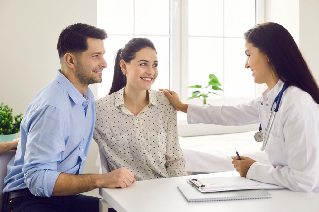 Couple consulting fertility specialist for irregular periods and ovulation issues