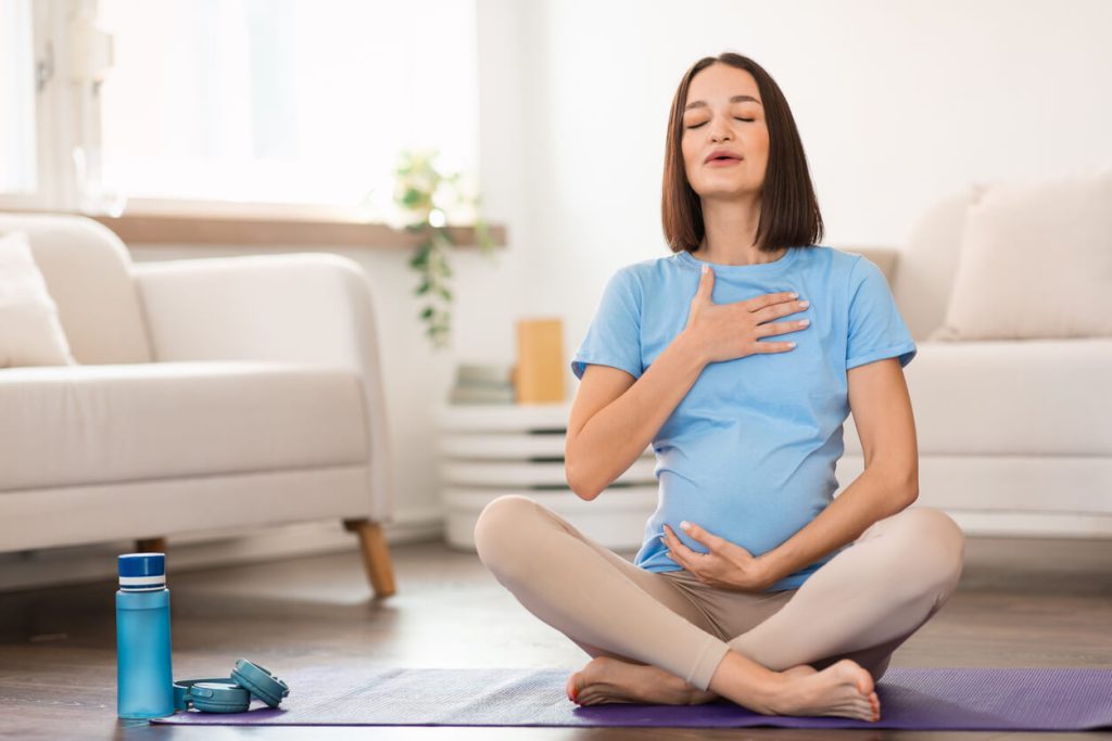 Pregnant woman meditating for peace during pregnancy