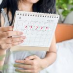 Woman tracking menstrual cycle for irregular periods